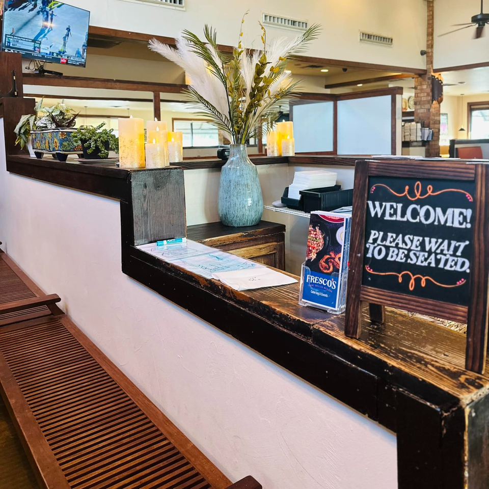 Fresco's Cocina Mexicana's waiting area with a "Please Wait To Be Seated" sign and decor.