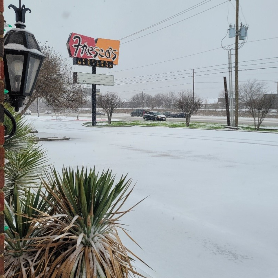 Fresco's Cocina Mexicana sign visible above a snow-covered parking lot and street with cars.